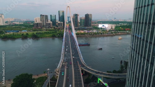 Aerial Shot of Ba Son Bridge Crossing Saigon River in Ho Chi Minh City
Shows evening road traffic commuting across the bridge connecting District 1 with the Thu Thiem urban area against a modern high-