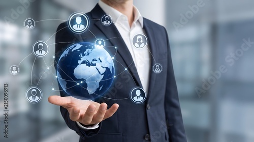 Businessman holding glowing globe with people network connections