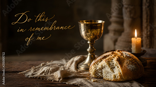 Communion elements of bread and a golden chalice on a rustic wooden table with a lit candle, representing the last supper and christian faith