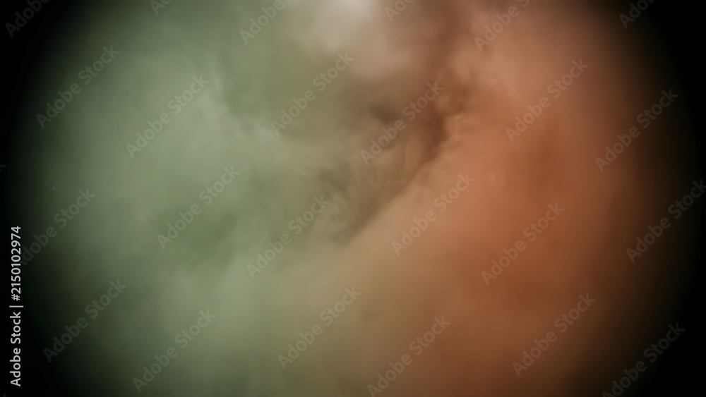 Obraz premium Abstract swirling clouds of green and orange smoke in darkness