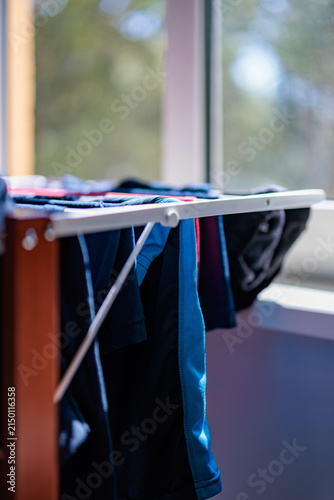 Fresh Laundry Drying on Indoor Rack by Sunlit Window