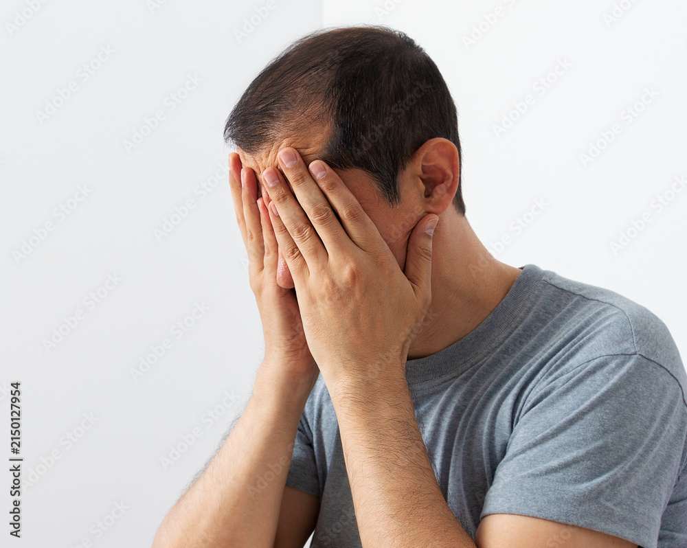 Fototapeta premium Full length shot of an hansome man looking depressed with white background.