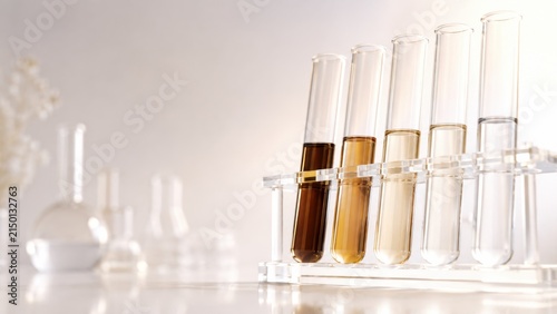 Laboratory test tubes with different colored liquid samples arranged in clear rack on white background