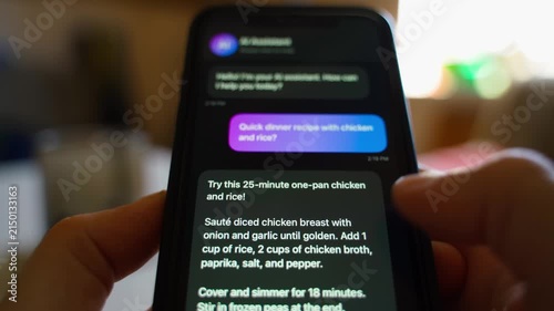 Hands holding smartphone with AI assistant chat asking for dinner recipe