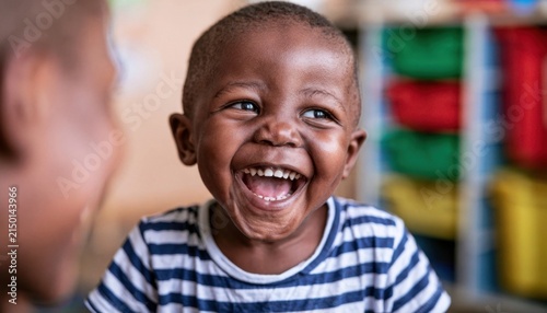 Joyful young boy with bright smile in striped shirt