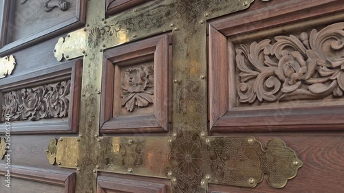 Close up of antique wooden door with brass details