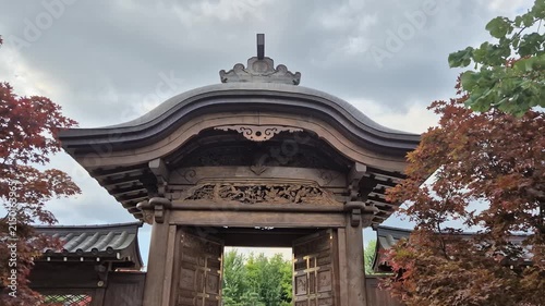 Traditional japanese karamon gate with autumn maple foliage