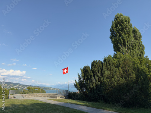 Curved Stone Terrace with Swiss Flag Overlooking a Lake Valley, Switzerland