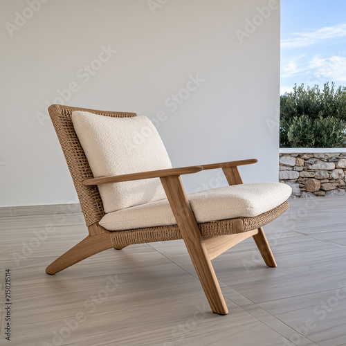 Natural wood lounge chair with woven rattan frame, cream cushion, modern minimalist design, outdoor patio, serene atmosphere