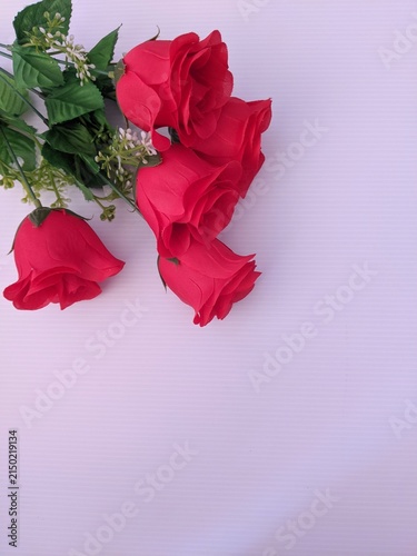 Template red rose flowers placed on a soft lavender background, flat lay. Copy space for editing purposes