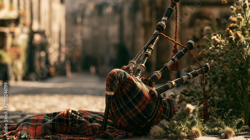 Traditional Scottish bagpipes centered in the composition, tartan fabric, thistle flowers and historic Scottish street softly blurred behind, premium cultural photography