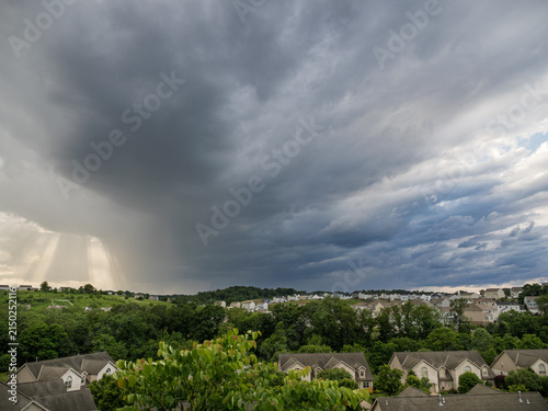 Canvas Print Ominous dark storm sky pouring rain over a distant Pennsylvania hill town