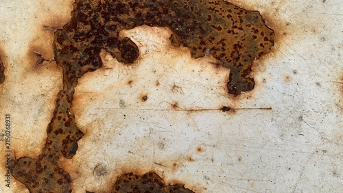 фотографія Rust spots and corrosion marks on a painted metal surface indicate material degr