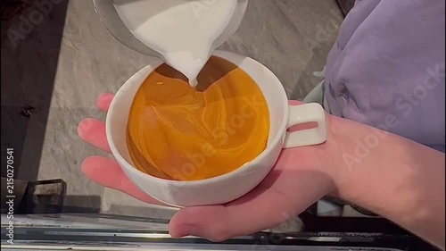 Close-Up POV of Barista Pouring Steamed Milk into Espresso to Create an Intricate Swan Latte Art Design