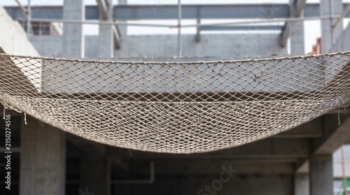 Safety Net Concept, a Taut Rope Safety Net Rigged Below to Catch a Fall on a Construction Site