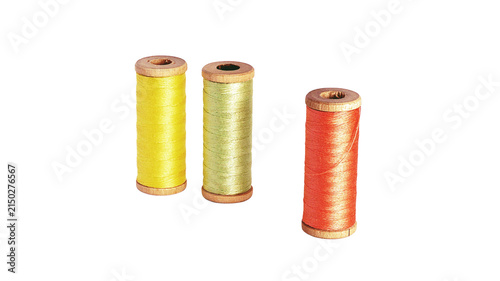 Fotografía Three colorful spools of thread for sewing and embroidery projects with embroide