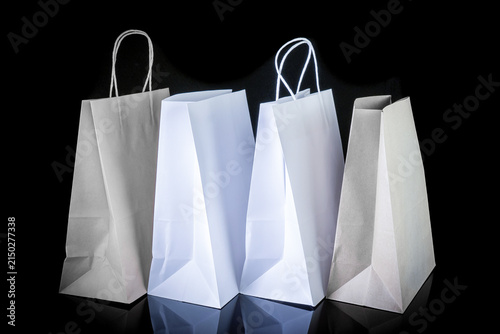 Set of paper bags for shopping on black background. Mockup for design