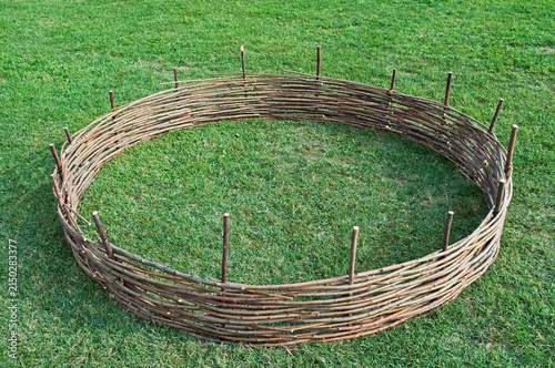 circular willow fence on green grass