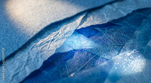 Abstract blue textile background with delicate leaf veins and shimmering decorative details