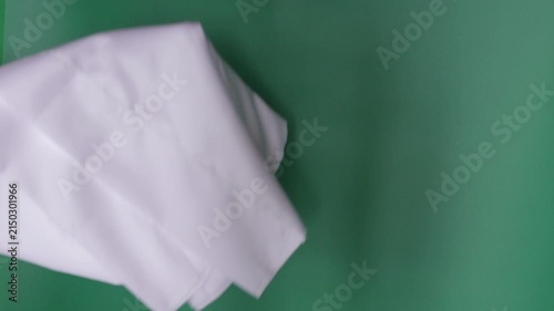 Male hand waving a white flag for surrender
