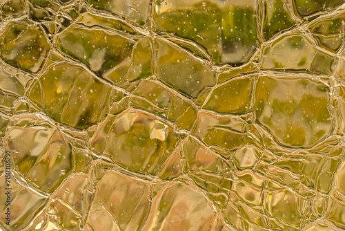 Obraz na plátne Close-up of golden textured glass with irregular reflections, abstract luxury ba
