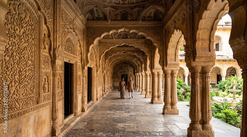 Indian Couple in Ornate Palace Corridor with Intricate Carvings and Arches