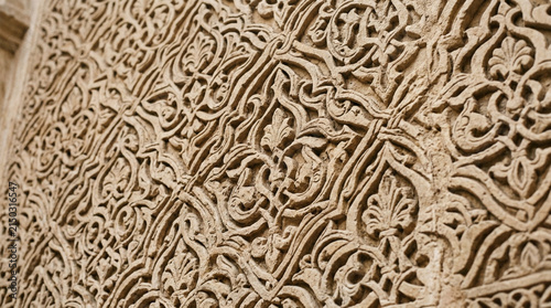 Intricate Arabic Geometric Carving on Ancient Stone Wall, Detailed Texture