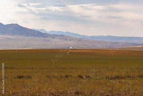 Cuadro en lienzo view of the steppe with a white yurt against the background of mountains