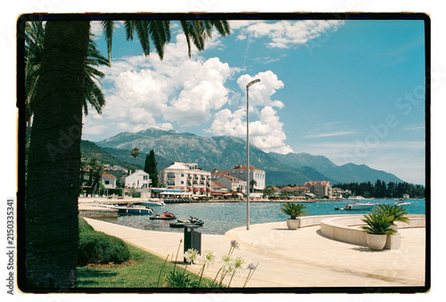 A Montenegrin promenade curves along a sun-bright bay