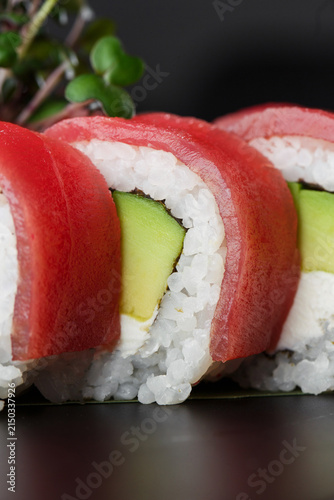 Фотография Macro Close-Up of Fresh Tuna Sushi Roll Filled with Avocado, Cream Cheese and Wh