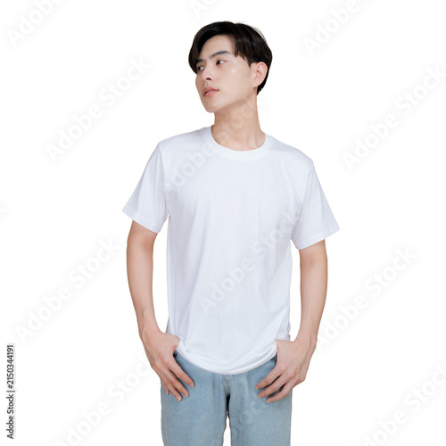 Young man wearing a plain white t-shirt and denim jeans, looking away