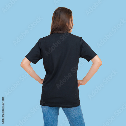 Woman wearing a plain black t-shirt and blue jeans, viewed from the back