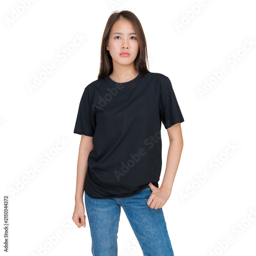 Young woman wearing a plain black t-shirt and blue jeans, standing against a white background