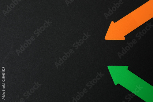 Paper arrow on color background, top view