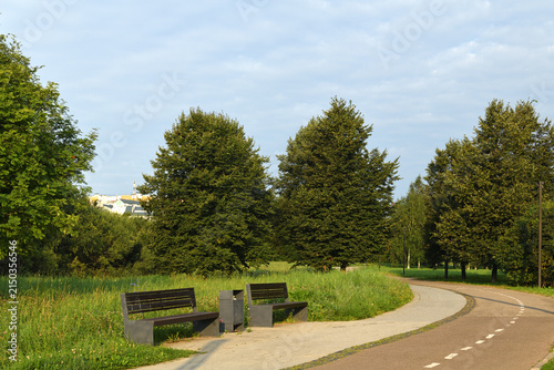 Benches and walkway in Mitino Landscape Park on sunny morning. Moscow, Russia