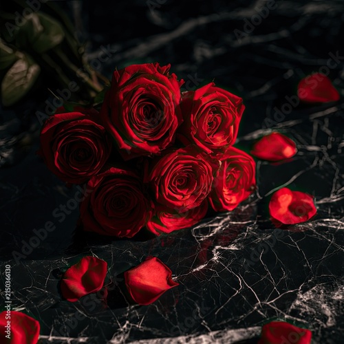A Dramatic Arrangement of Red Roses on a Dark Marble Surface.