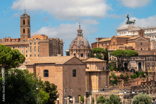 View across the Roman Forum with The Curia Julia, Church Santi Luca and Martina, the Bell Tower of the Palazzo Senatorio and Monument to Victor Emmanuel II.