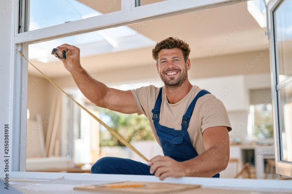 Fototapeta premium Worker measuring window opening with tape measure