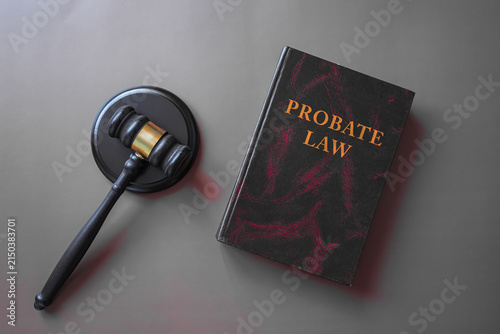 Judge wooden gavel on Probate Law dark book on gray background, inheritance and court justice concept