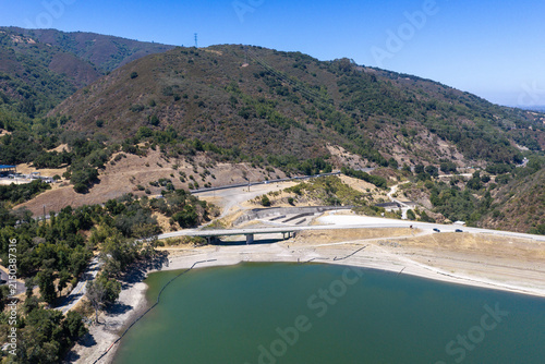 Lexington Reservoir, a crucial water source in Los Gatos, California, showing significantly low water levels and exposed shoreline, highlighting environmental concerns and water scarcity