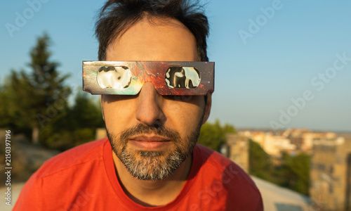 Man observing a solar eclipse using protective glasses