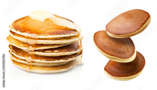 Картината върху платно Stack of golden pancakes with melting butter and syrup beside floating dorayaki