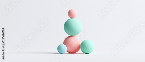 Minimalist stacked pastel spheres and balls balance composition isolated on white background banner