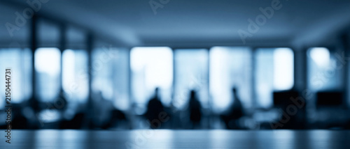 Blurred modern corporate office interior background with silhouette of business people meeting and empty table top