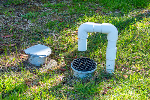 фотографія Photograph of a PVC water pipe and drain system used for backwashing the sand fi
