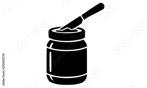 Black silhouette of an open jar with a spreader knife on top, a bold vector food icon representing condiments, peanut butter, jam, or honey perfect for kitchen and grocery design projects