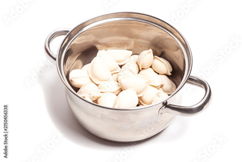 vareniki with potatoes in a saucepan isolated on white background