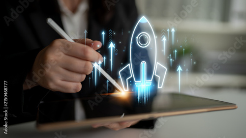 Fotografie Business Professional Using Tablet to Illustrate Innovative Ideas with Rocket La