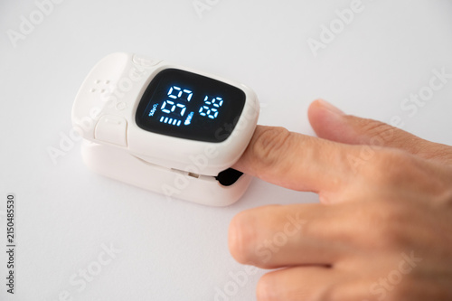 Photography Pulse oximeter measuring blood oxygen saturation on finger