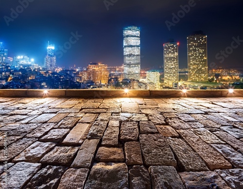 stone wall with city lights at night